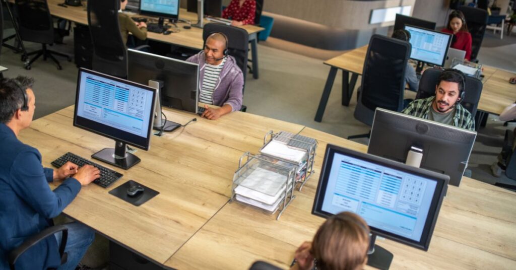 Employees providing technical support in a busy IT GOAT call center, ensuring seamless customer service.