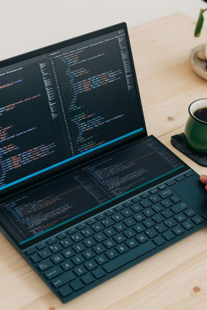 Laptop with coding software, representing IT consulting and strategy services offered by IT GOAT in Austin, TX.