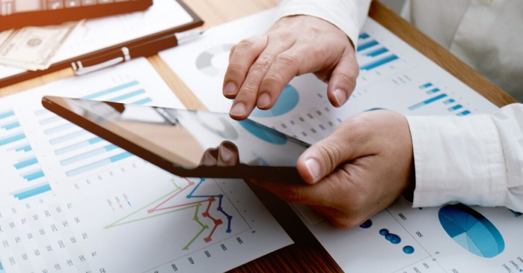 A business professional reviewing cybersecurity statistics on a tablet, showcasing IT GOAT's data-driven approach to preventing social engineering attacks.