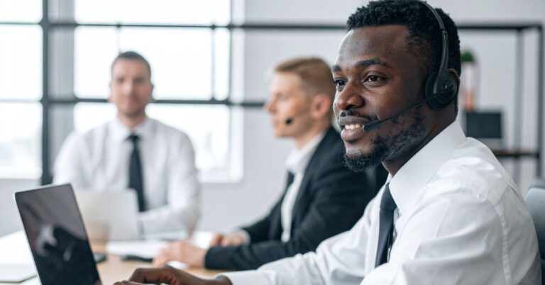 Executive assistant at a financial firm smiling while submitting an IT support ticket.